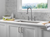 Llave para cocina tipo puente extensible con dos manijas